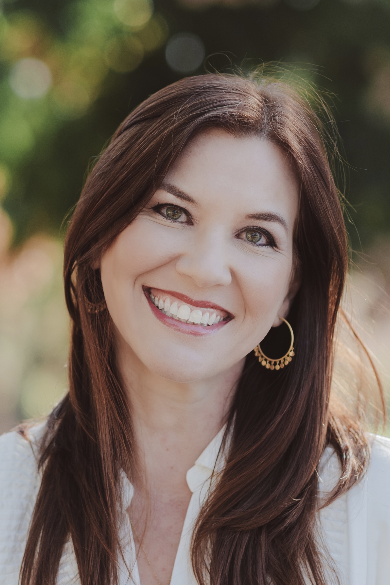 Andrea Guido LCSW headshot, smiling, neutral background